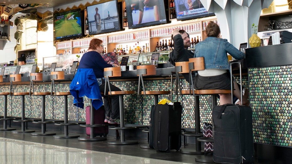 Flight Passenger's Bar Buddy Called Out for Seat Squatting: 'So Awkward'